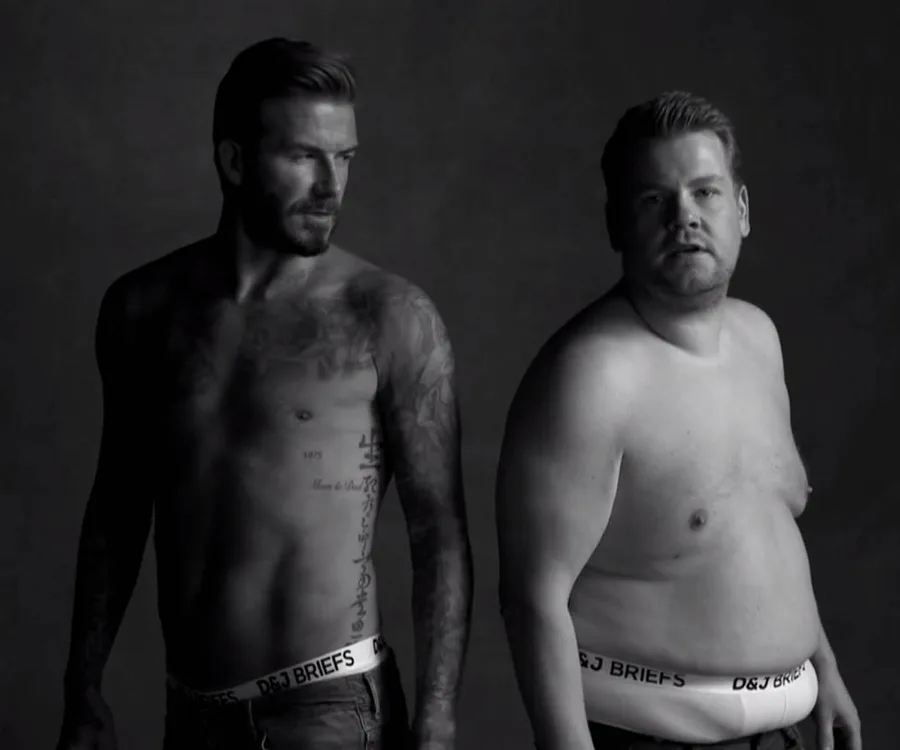 Two men in branded underwear pose shirtless against a dark background.