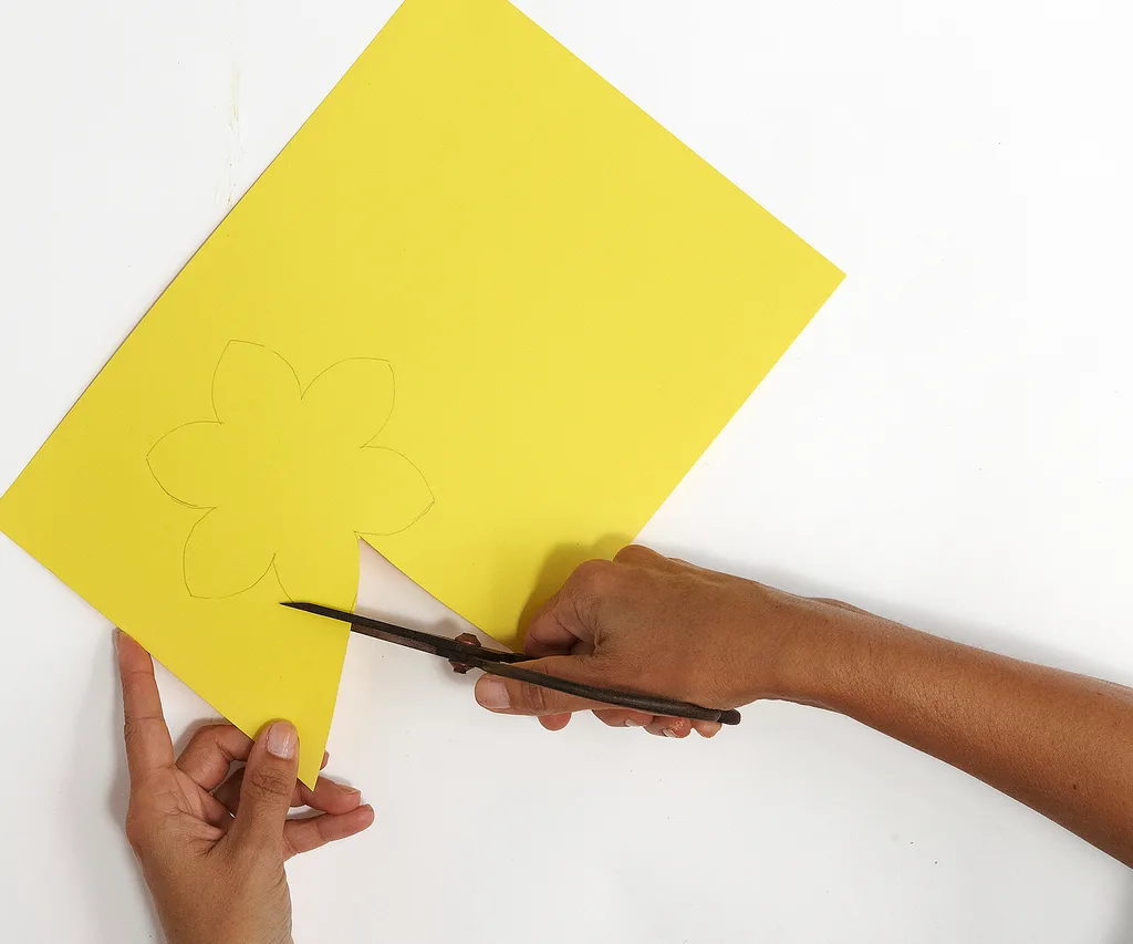 hands cutting craft paper