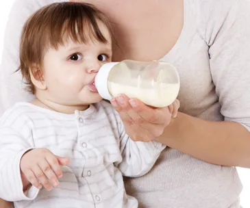 Baby feeding from a bottle