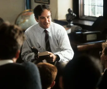 Teacher discussing a book with students in a classroom setting.