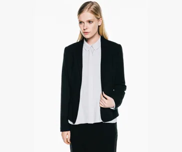 Business attire with black blazer and white blouse, modern winter workwear for women.