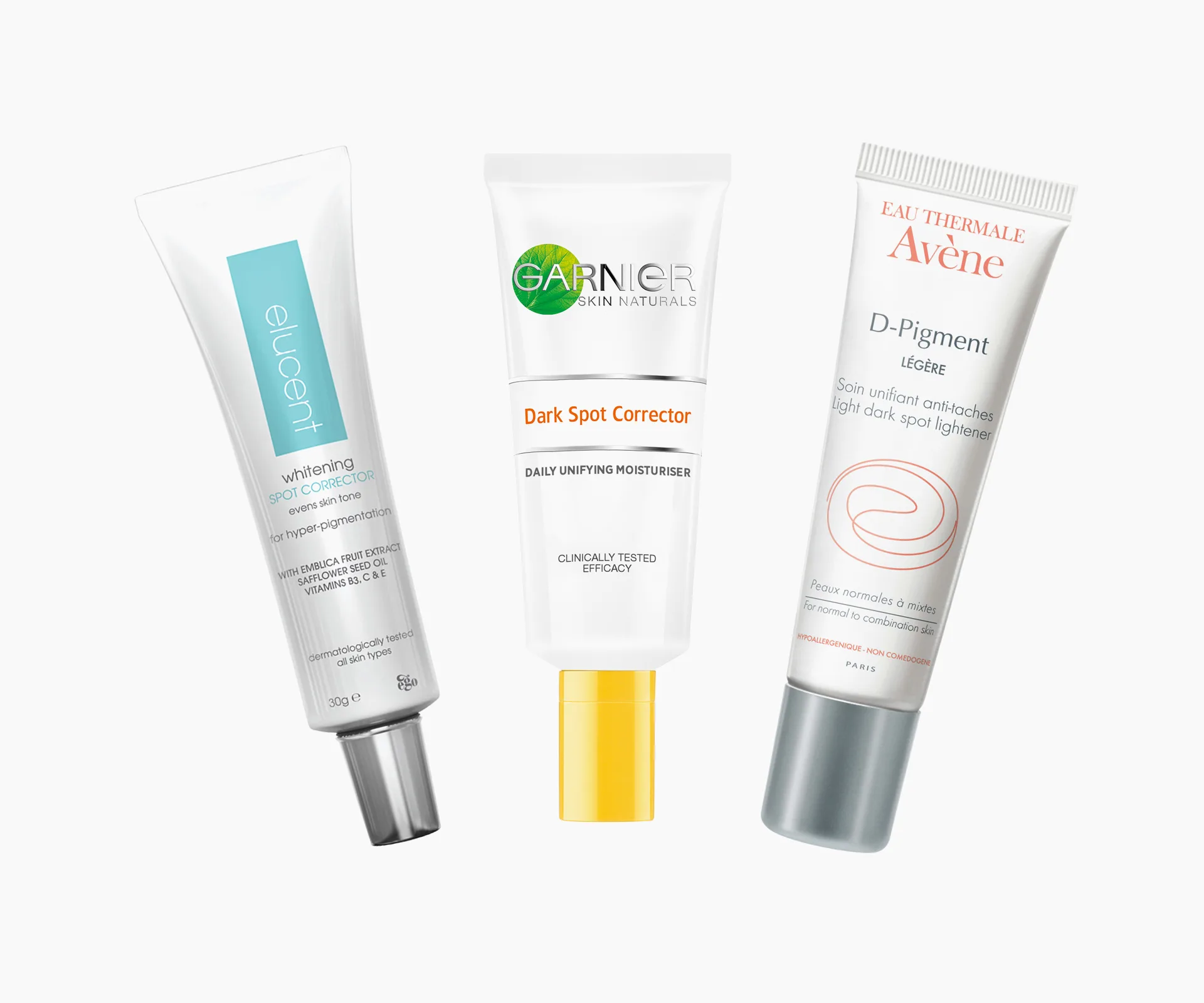 Three skincare tubes: Elucent Whitening Spot Corrector, Garnier Dark Spot Corrector, Avène D-Pigment.