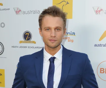 Man in a blue suit at an event for the 7th Heath Ledger Scholarship.