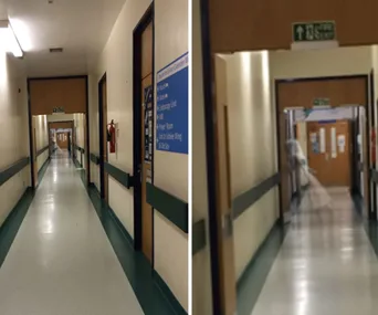 A hospital corridor with a blurry, ghostly figure appearing at the end, creating a spooky atmosphere.