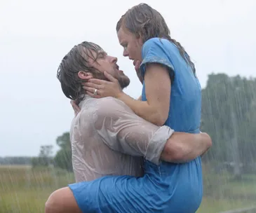A couple embracing passionately in the rain, conveying intense emotion and romance.