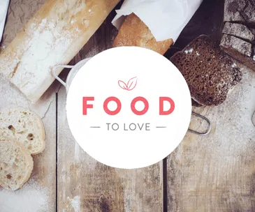 Bread varieties on a wooden table with "Food To Love" logo in the foreground.