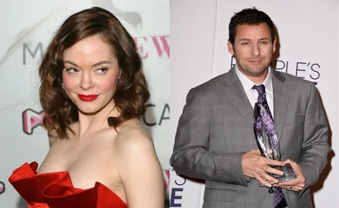 Actors in formal attire at an event; one in a red dress, the other in a suit holding an award.