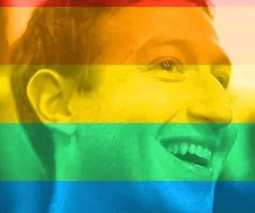 Man smiling with a rainbow filter overlay.