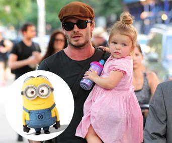 "Man carrying a young girl with a sippy cup on a city street, Minion character illustration in the bottom left corner."