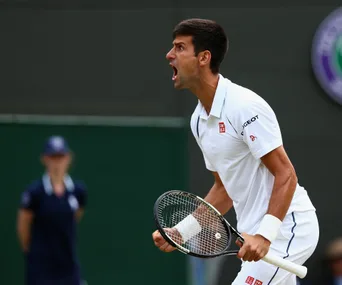 Tennis player expressing frustration on court, with a blurred figure in the background.