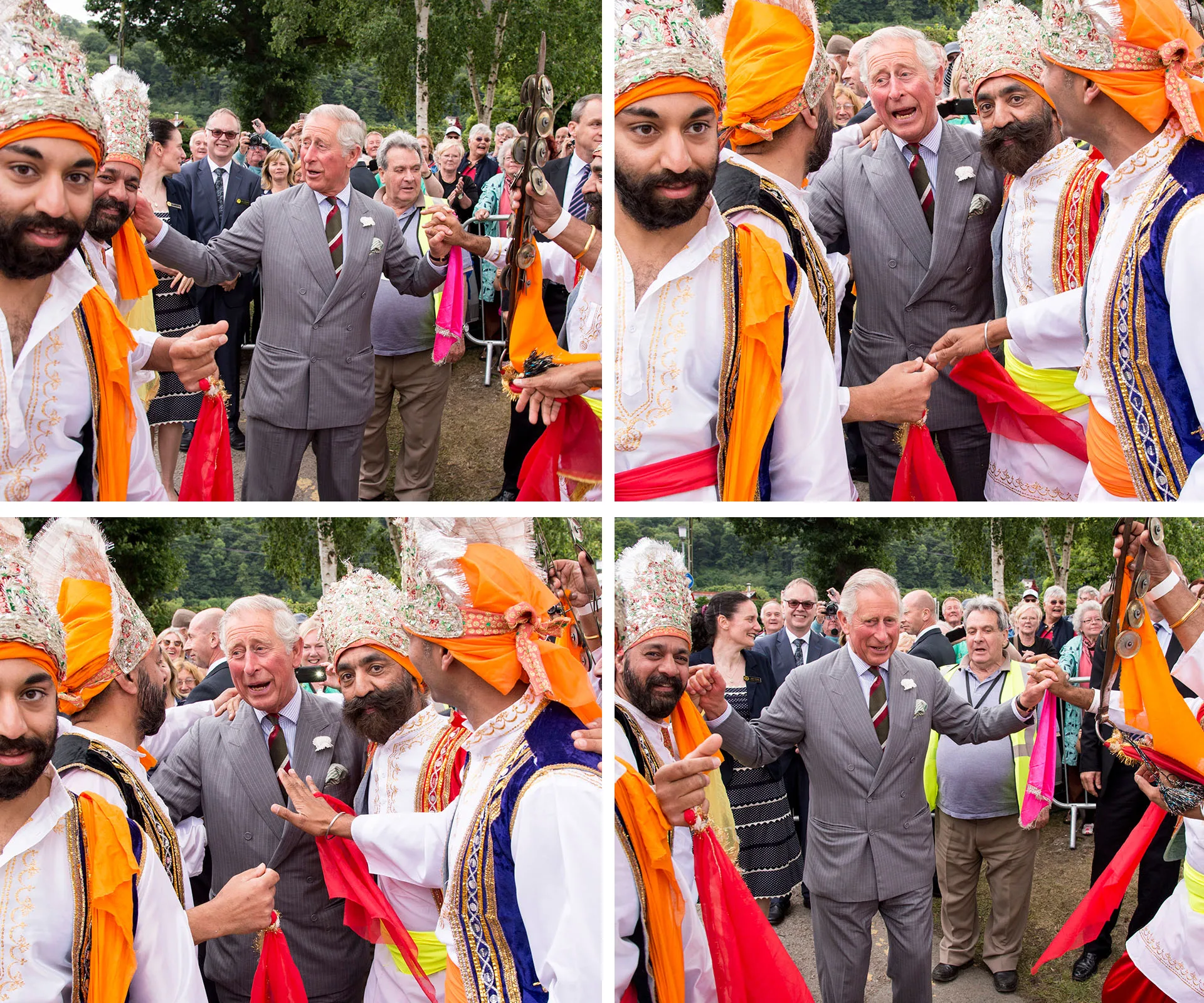 Prince Charles dancing with performers in traditional costumes at an outdoor event in Wales.