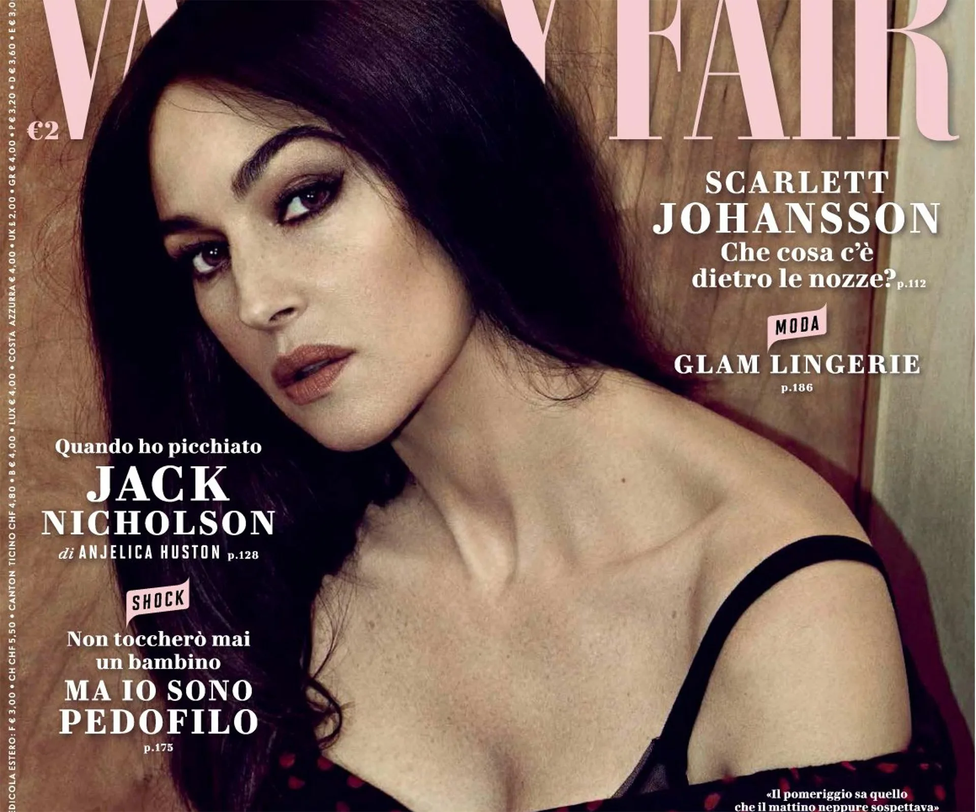 Woman with long dark hair in a black dress, posing for a Vanity Fair magazine cover.