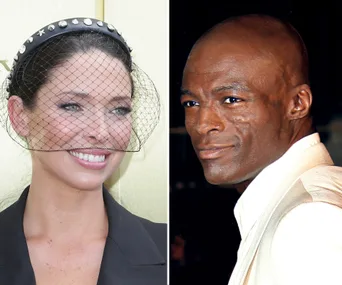 Two people photographed smiling; left person with a netted headpiece, right person in a light suit.