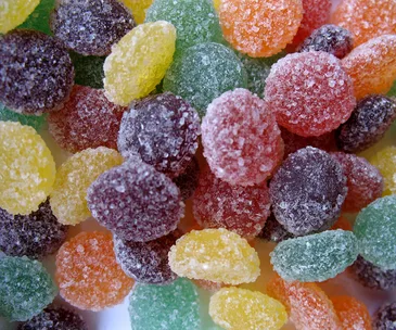 Colorful sugar-coated jelly candies in various shapes and flavors.
