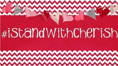 #IStandWithCherish text on zigzag red and white background with heart garland above.