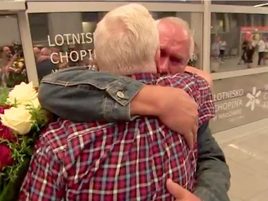 Elderly twins emotionally embrace at an airport reunion after being separated for 68 years.