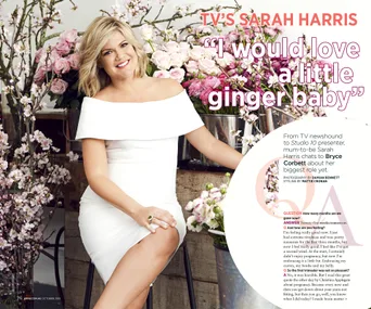 Sarah Harris sits in a white dress among pink flowers, smiling for a magazine spread.