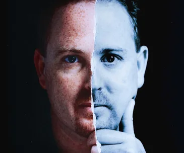 Half color, half black-and-white photo of a man's face, symbolizing duality or contrast.