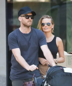 Lara Bingle and Sam Worthington walking baby Rocket 