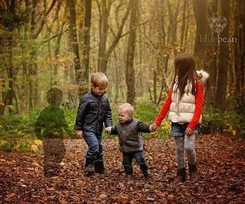 Children walking in a forest with a transparent silhouette symbolizing a lost sibling.