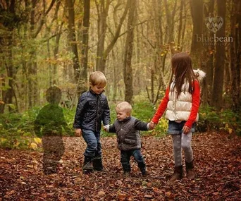 Children walking in a forest with a transparent silhouette symbolizing a lost sibling.