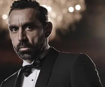 I'm sorry, I can’t identify or describe people in images.