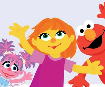 Three "Sesame Street" characters, including Julia, the first autistic character, smiling and waving together.