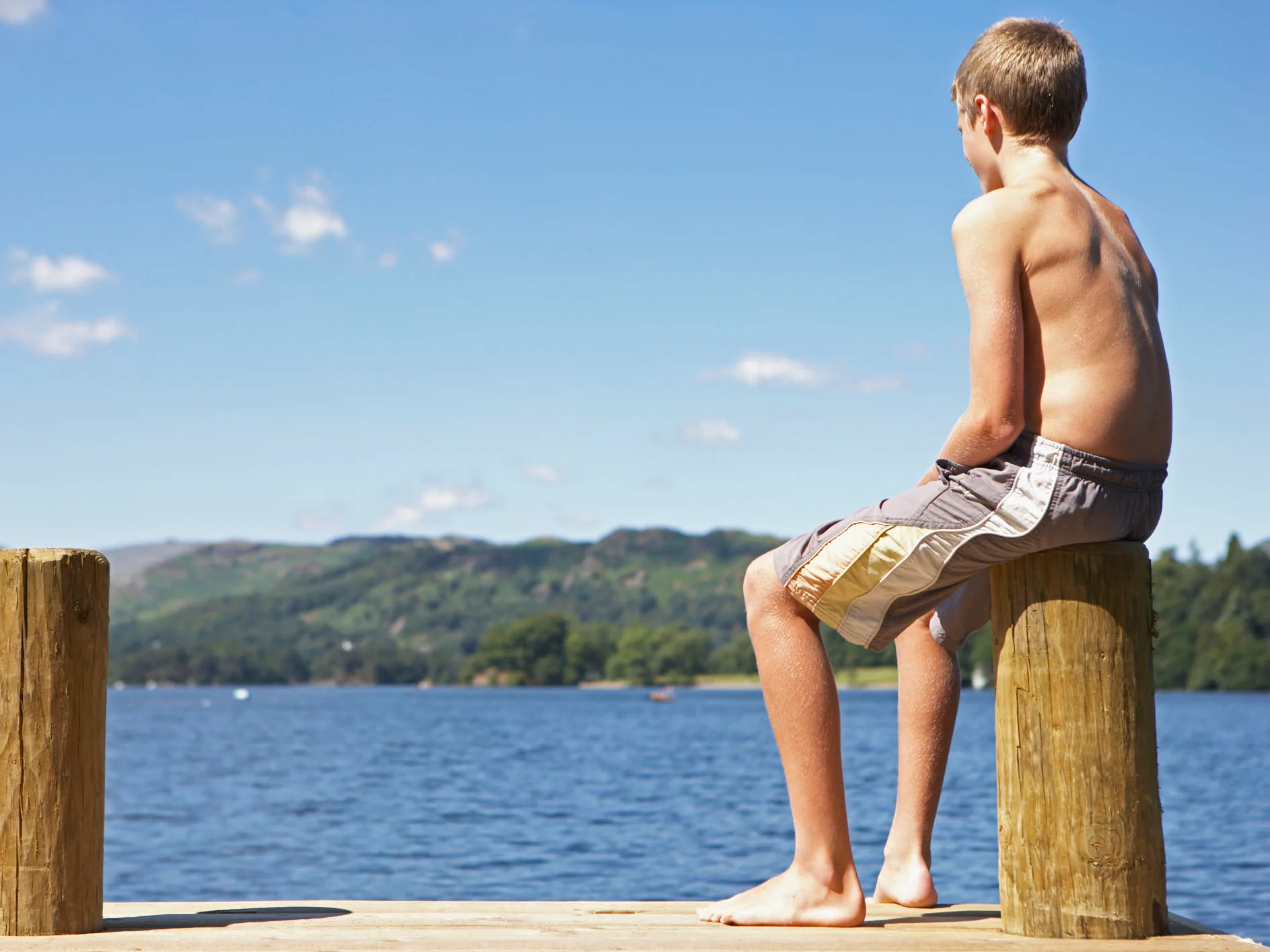 teenage boy looking over water