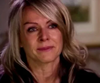 Woman with blonde hair appears emotional in an interview setting.