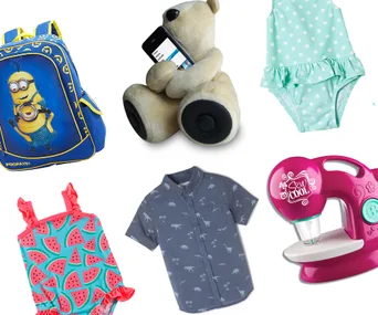 A selection of kids' holiday gifts, including a Minions backpack, plush bear speaker, swimsuits, dinosaur shirt, and toy sewing machine.