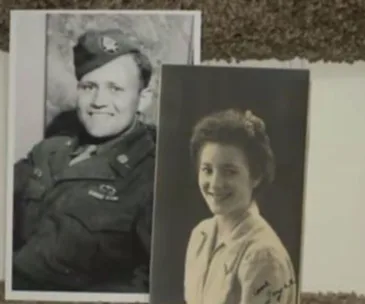 A vintage photo of a smiling soldier in uniform and a young woman in a blouse, symbolizing reuniting after 70 years.