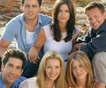 A group photo of six main characters from the TV show "Friends" sitting closely together outdoors.