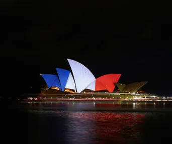 Sydney Opera House illuminated in blue, white, and red to honor Paris attack victims.