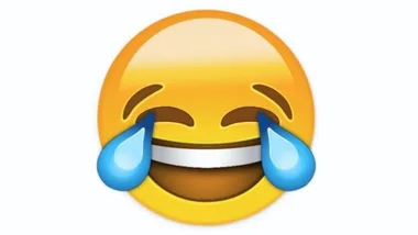 Emoji of a face laughing with tears of joy, with a wide smile and tears flowing from both eyes.