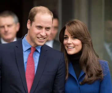 Prince William and Catherine smiling together at a public event.