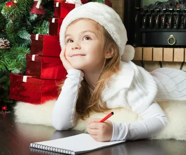 Little girl writing to Santa