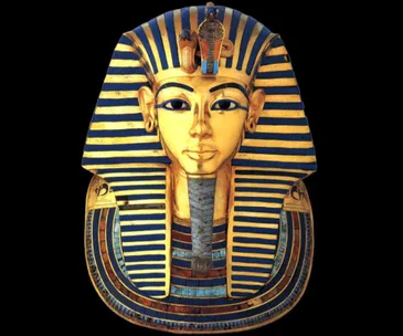 Golden mask of King Tutankhamun with blue and gold striped headdress and serene expression.