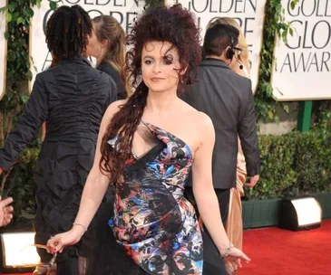 Helena Bonham Carter at the Golden Globes, wearing a colorful patterned dress with a tulle skirt and tousled hairstyle.