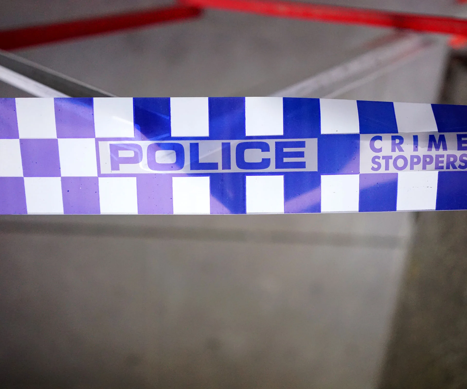 Blue and white police tape with "Crime Stoppers" text.
