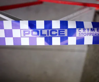 Blue and white police tape with "Crime Stoppers" text.
