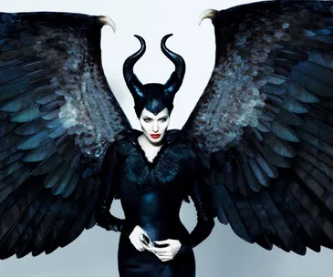 Maleficent in black attire with large wings and horns against a white background.
