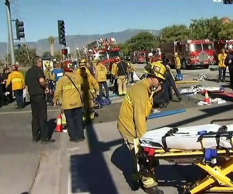 Emergency responders at a scene with fire trucks and stretcher in California after a shooting.