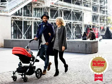 Couple walking outdoors with a red stroller; Mother & Baby Awards 2013 badge in the corner.