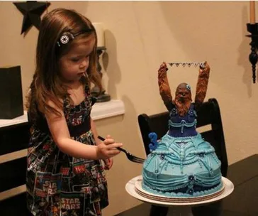 Child with a Star Wars dress and Chewbacca cake in a blue dress.