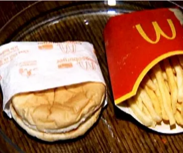 A six-year-old McDonald's burger and fries appear unspoiled on a plate.