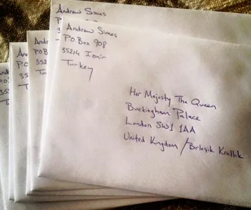 Envelopes addressed to the Queen at Buckingham Palace and Andrew Simes in Turkey are shown in a stack.