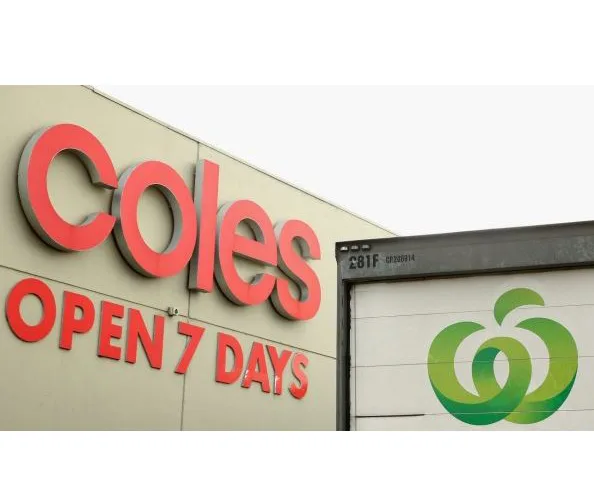 Coles supermarket sign with "Open 7 Days" and a truck with Woolworths logo.
