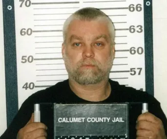 Mugshot of a man with gray hair and beard holding a "Calumet County Jail" sign, standing in front of a height chart.
