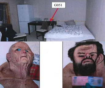 Alt text: "Room with a bed and refrigerator, and masks of elderly and bearded faces on display."
