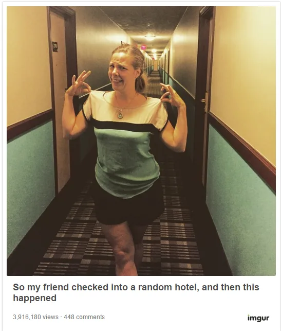 Woman standing in a hotel hallway wearing a shirt that matches the wall design humorously.